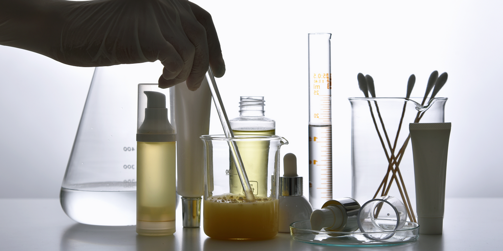 Hand stirring chemicals in lab