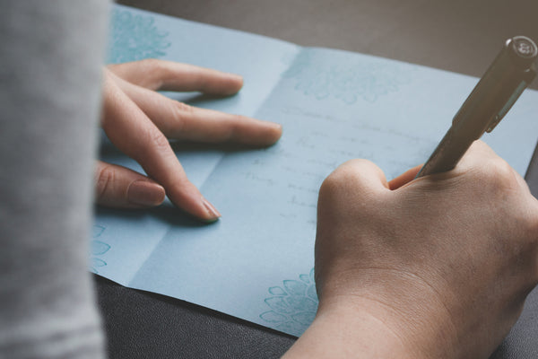 woman-writing-a-get-well-soon-message