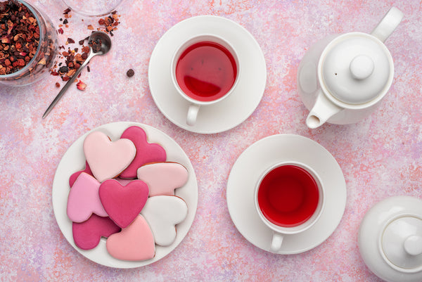 Pink heart-shaped cookies and tea cups