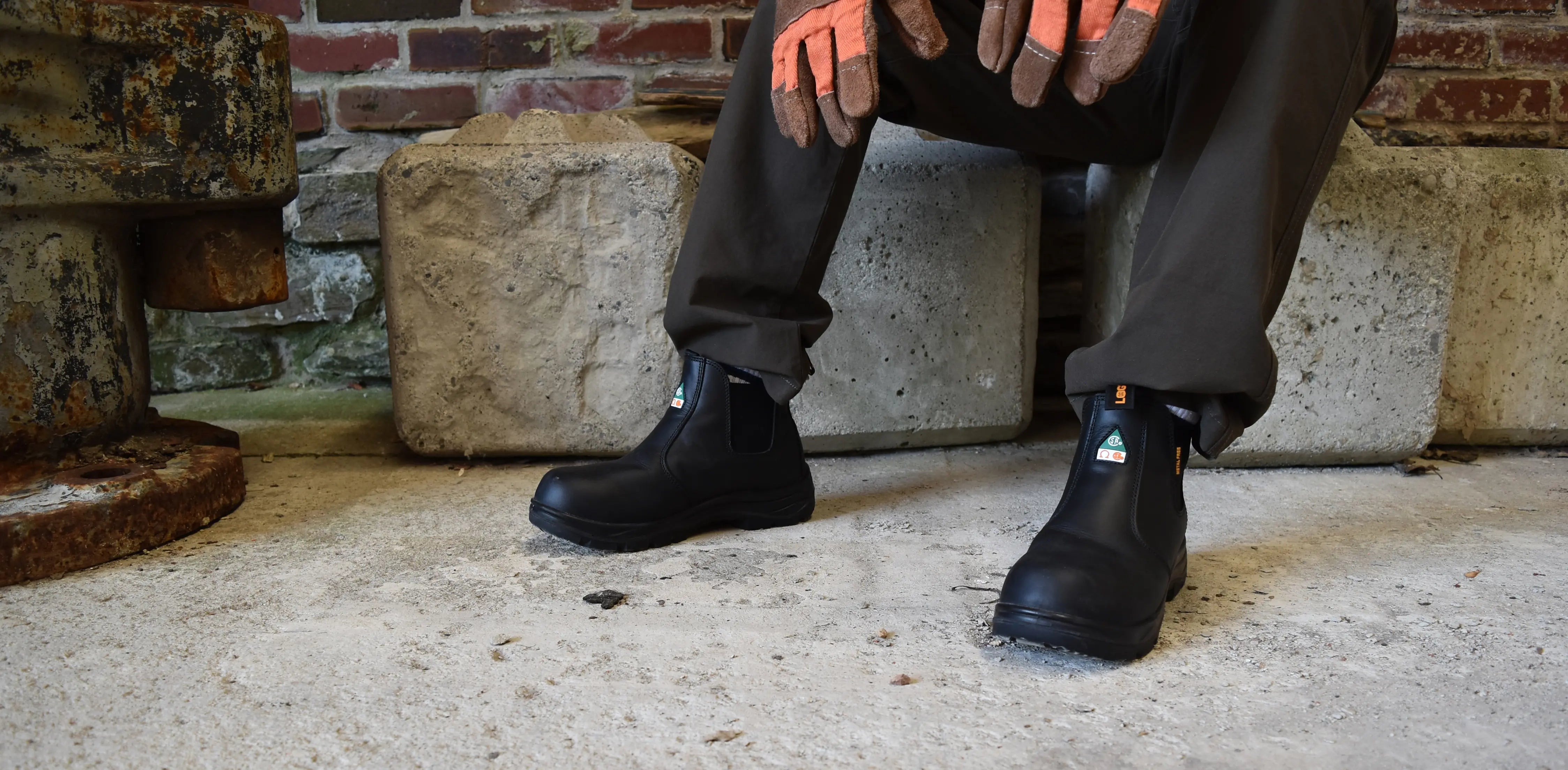 Welder resting in MooseLog Timber Boots