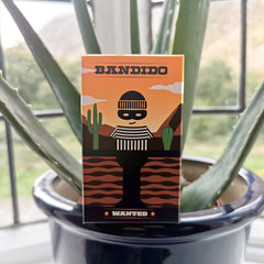 Bandido card game box on top of plant pot