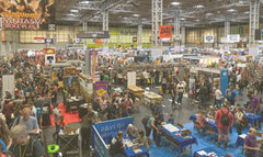 Image of a large crowd of people around different stands at the UK Games Expo 2023 in NEC, Birmingham