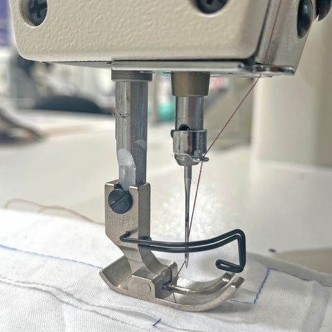 Close up of a needle feed sewing machine foot