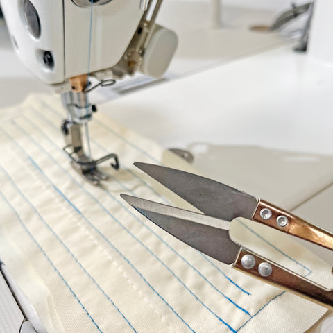 Image showing snips next to an industrial sewing machine needle
