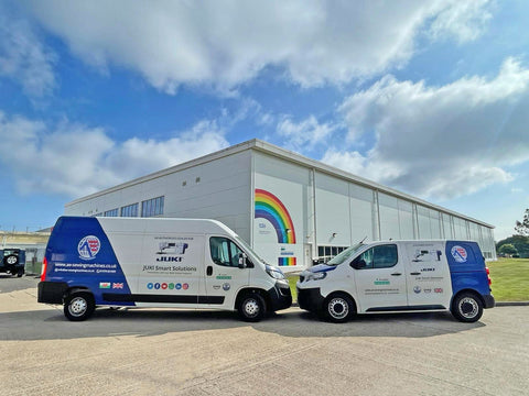 Image showing two AE Sewing Machines vans in front of an NHS factory