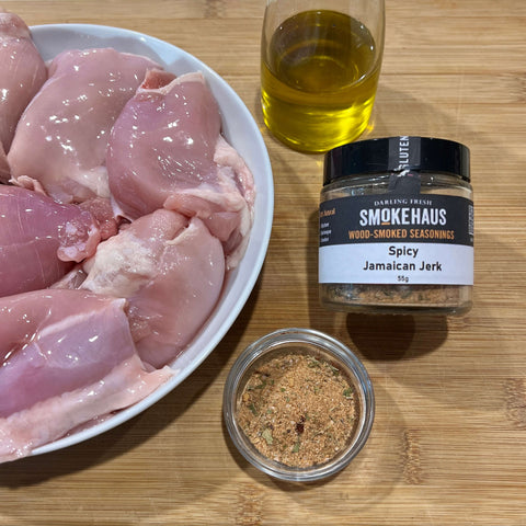 Chicken fillets on a plate, a small bottle of oil and a jar of DF Smoke Haus Wood-Smoked Seasoning