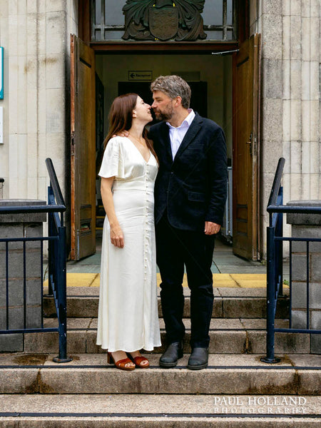 Wedding couple on the steps outside Kendal Register Office