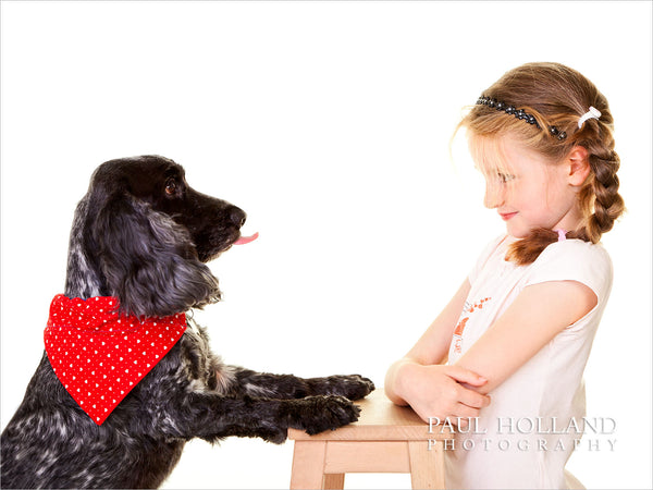 Photo showing a dog sticking it's tongue out at it's young owner
