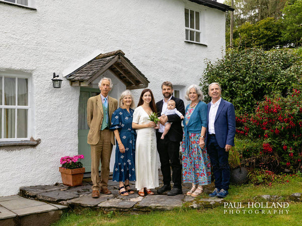 Group wedding photo outside the cottage