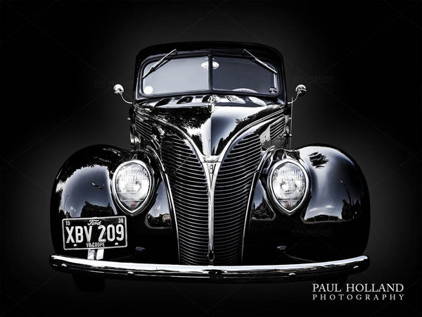 A photograph of the Ford Coupe against a black background