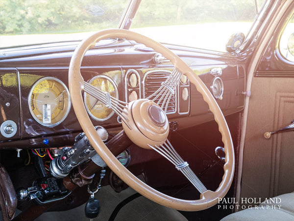 Interior of the Ford Business Coupe showing the steering wheel and dashboard