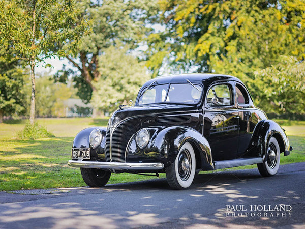 Photograph of the vintage Ford V8 Business Coupe parked on the road