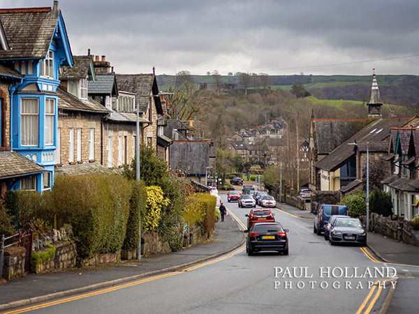 Image shows a street view with Kendal Castle in the distance