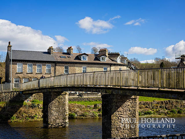 Image shows a pedestrian foot bridge over a river