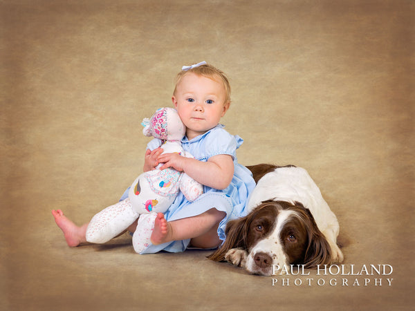 Image of a young girl sitting next to a spaniel dog