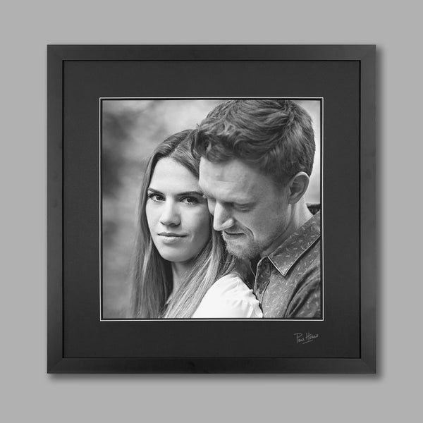Black and white image of a couple in a black frame