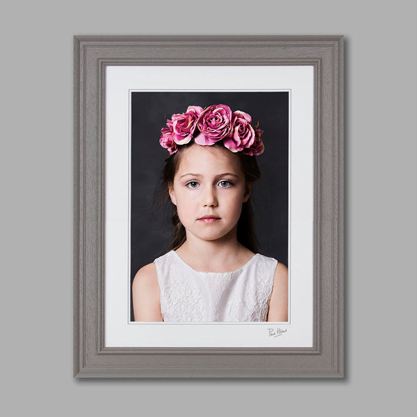A fine art portrait of a girl in a large grey frame