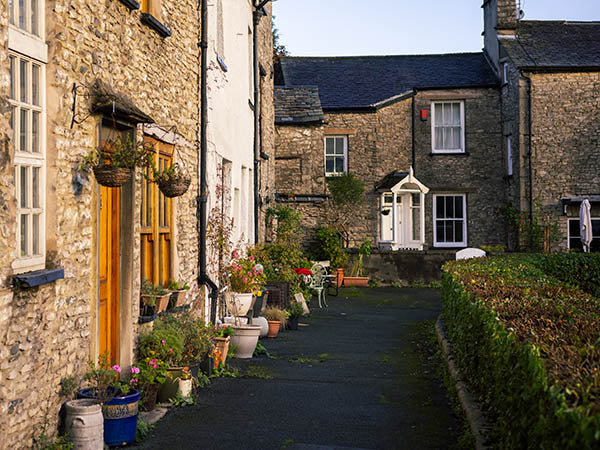 Image shows a quiet lane in Kendal in bathed in early morning sunlight