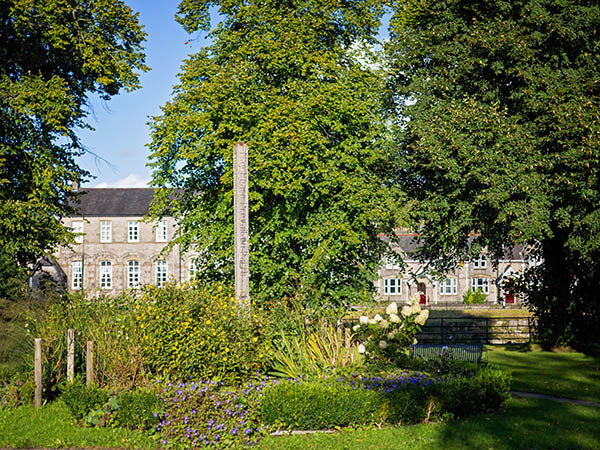 Image shows the peace pole in Kendal Peace Garden