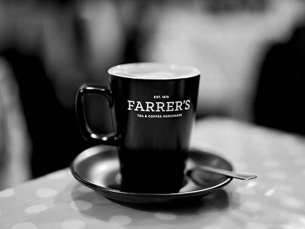 Black and white image showing a cup of coffee on a saucer