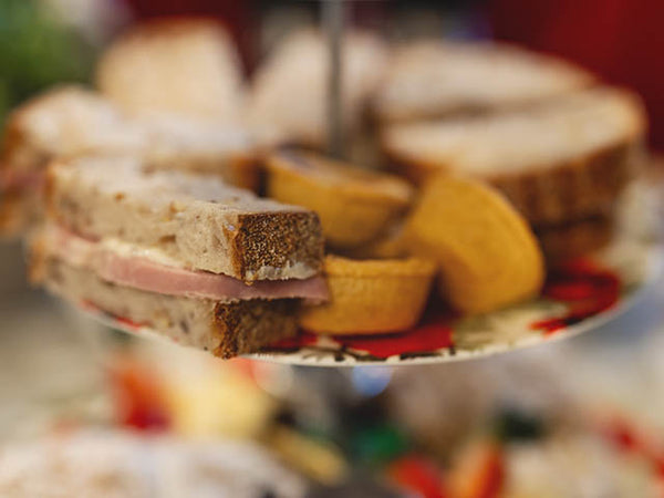 Image shows afternoon tea food on a cake stand