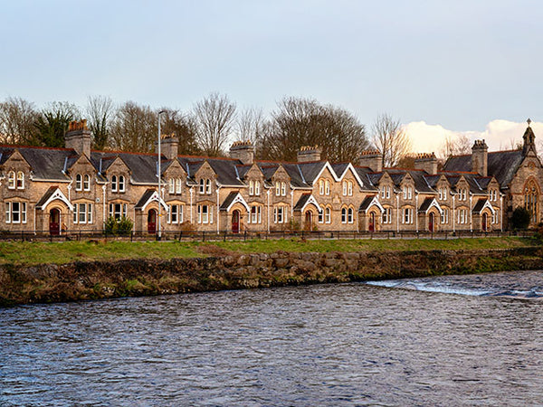 Images shows a terraced row of houses facing the River Kent