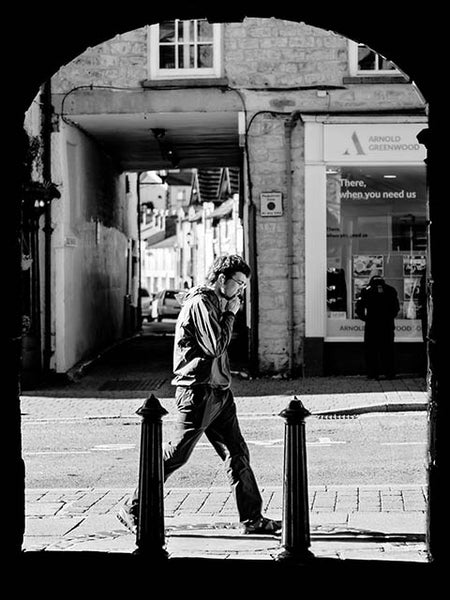 Black and white image of a man walking