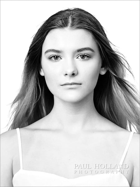 A black and white portrait of a girl on a bright white background