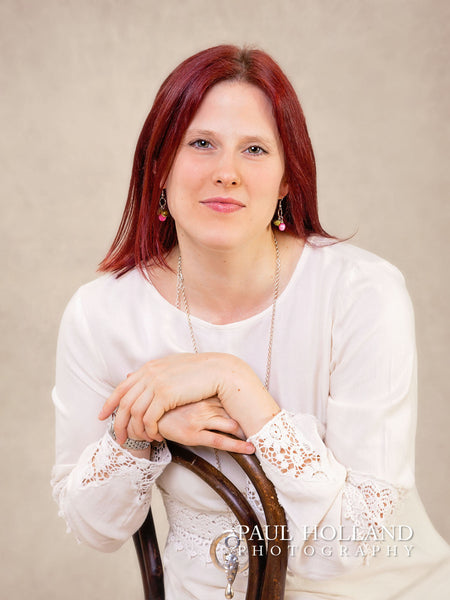 Image shows a woman sitting on a chair