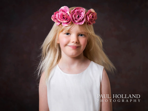 A fine art portrait by Paul Holland of a young girl wearing a flower crown