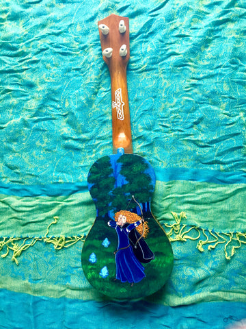 Hand painted ukulele depicting Merida, the main character from Disney Pixar's BRAVE. Will-O-wisps are next to her, she's drawing her bow with arrow aimed. She is standing in front of a dense forest.