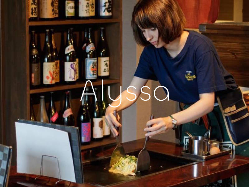 Woman making Okonomiyaki in a Japanese restaurant