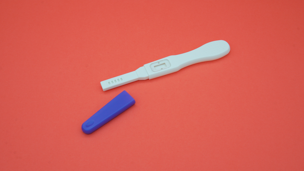 uncapped twoplus Fertility pregnancy test kit on red background