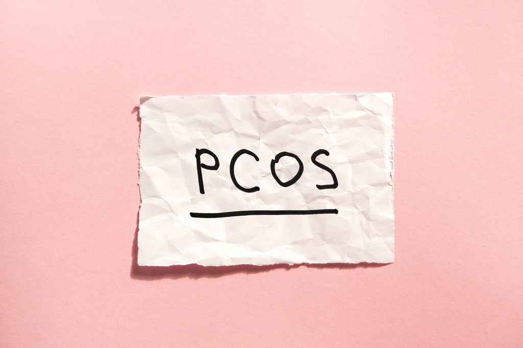 crumpled note with PCOS written on it