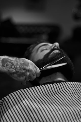 Barber trimming hair