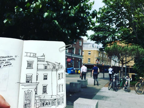 A timed sketch of Bermondsey St in an open sketchbook with the street behind