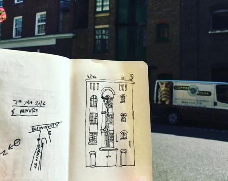 An open sketchbook with a line drawing of a street in Bermondsey