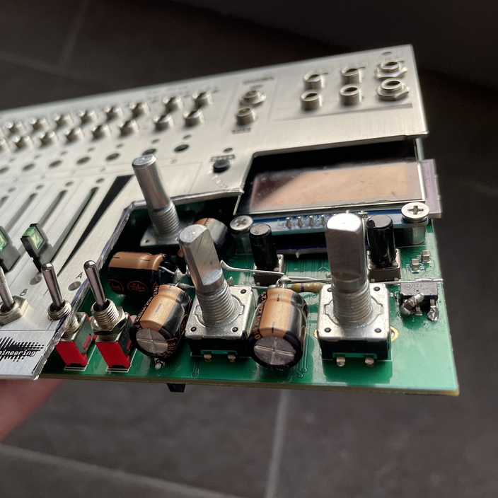 A Xer Mixa prototype with the bottom right corner chopped off the panel so that large capacitors could be installed