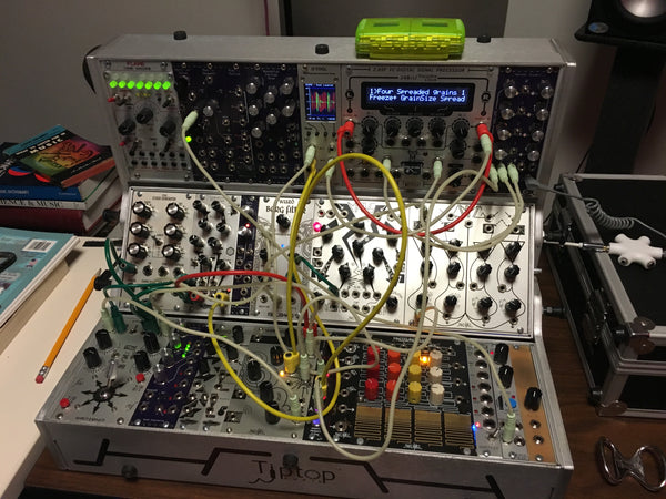 A three-row system filled with older Eurorack modules patched together for a sound design task