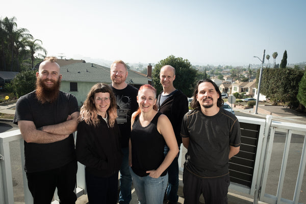 Markus, Elana, Patrick, Kris, Adam, and Stephen on their porch looking over Los Angeles