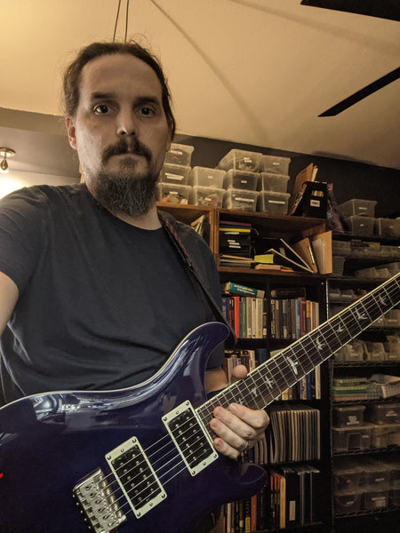 Stephen taking a selfie holding a purple guitar