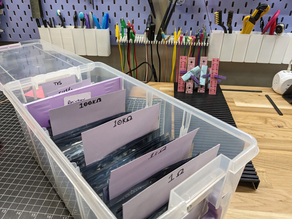 A box of Mouser bags on Winterbloom's workshop desk, with partly-assembled moules in the background