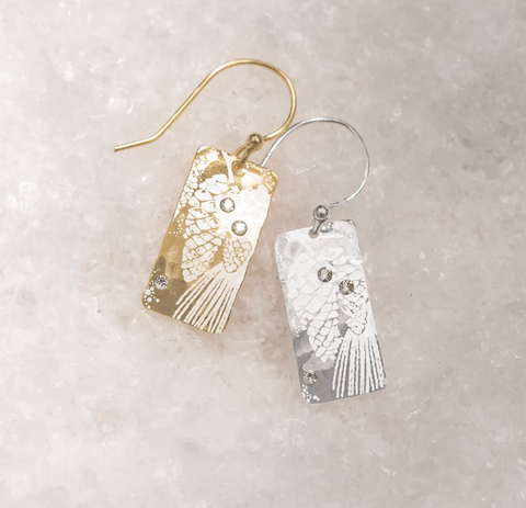 silver and gold rectangular earrings with pine boughs and pine cones