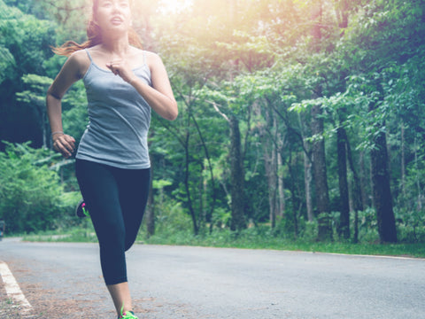 fitness girl jogging through a street