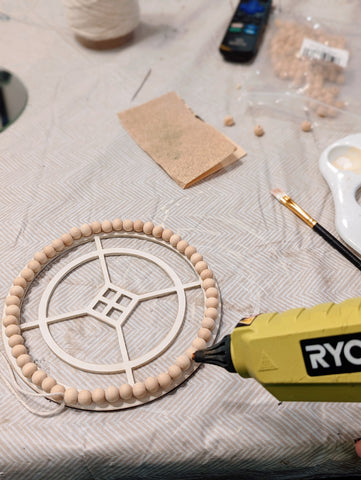 glue the wooden beads to the laser cut wood frame