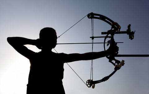 Man adjusts compound bow