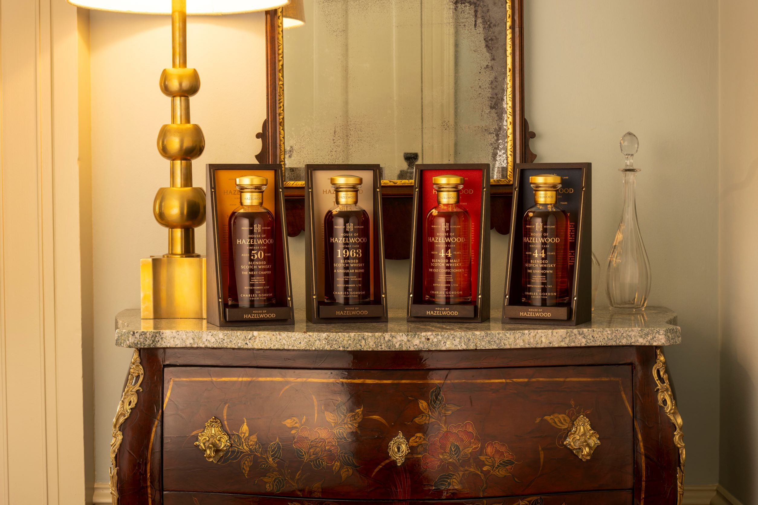Four bottles from The Charles Gordon Collection sitting on top of a dresser.