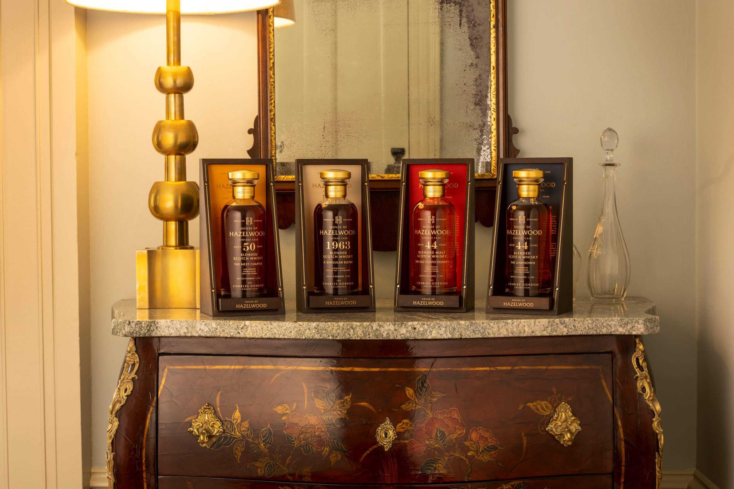 Four bottles of The Charles Gordon Collection sitting on a dresser.