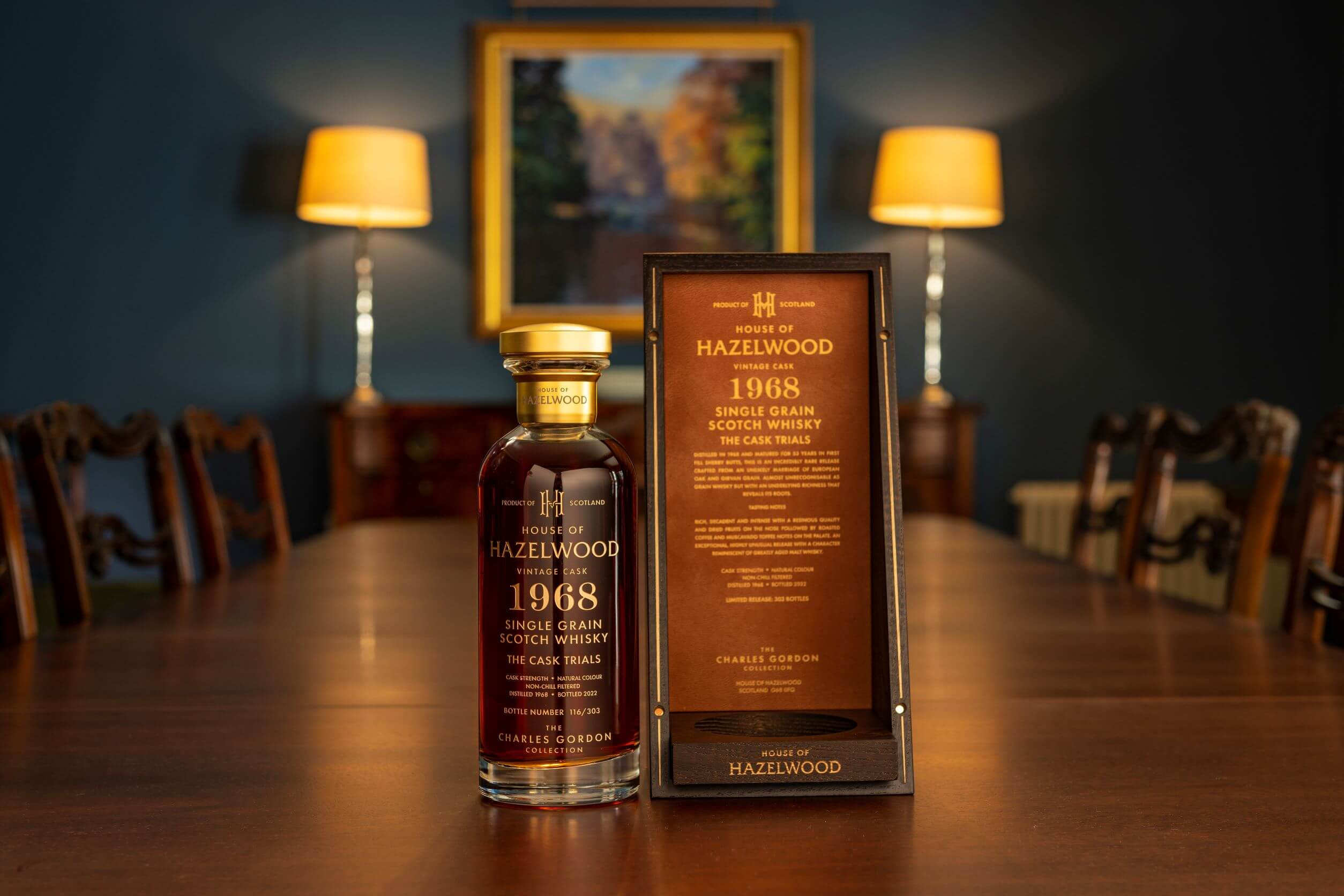 A bottle of The Cask Trials sitting on a table next to it's box.