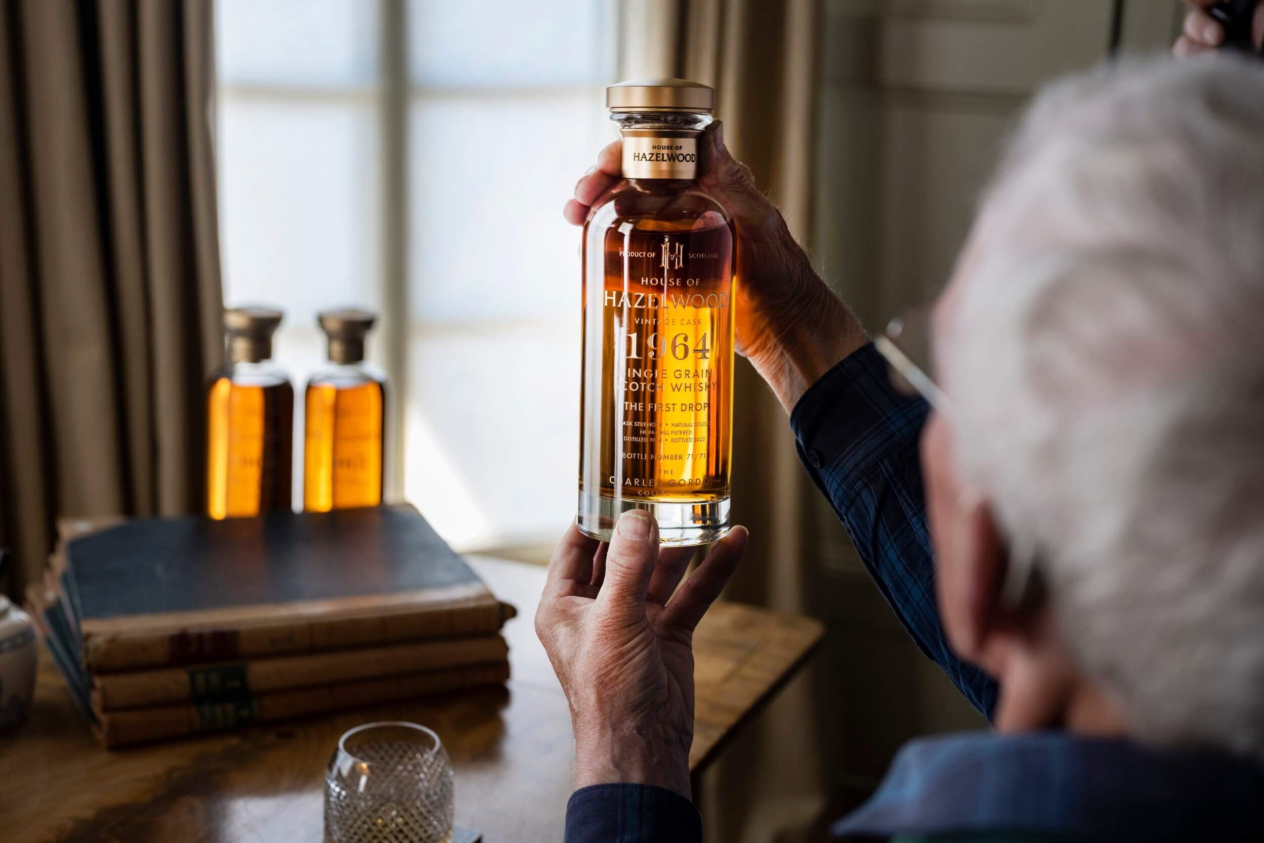 A Whisky expert examining a bottle of The First Drop.